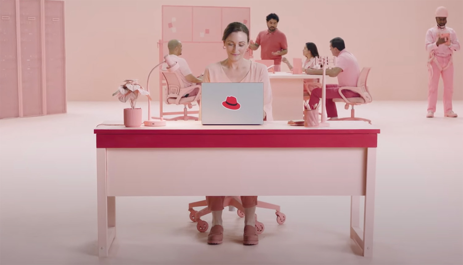 A screenshot from a video in the Connected Campaign series showing a woman working at a laptop with the hat on the back of the laptop screen.