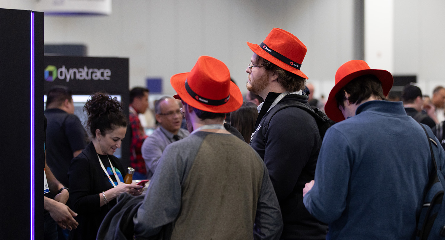 Attendees at Red Hat Summit wear special event fedoras.