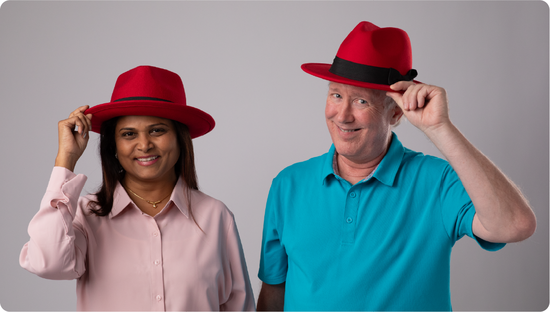 Two Red Hatters wearing their fedoras.