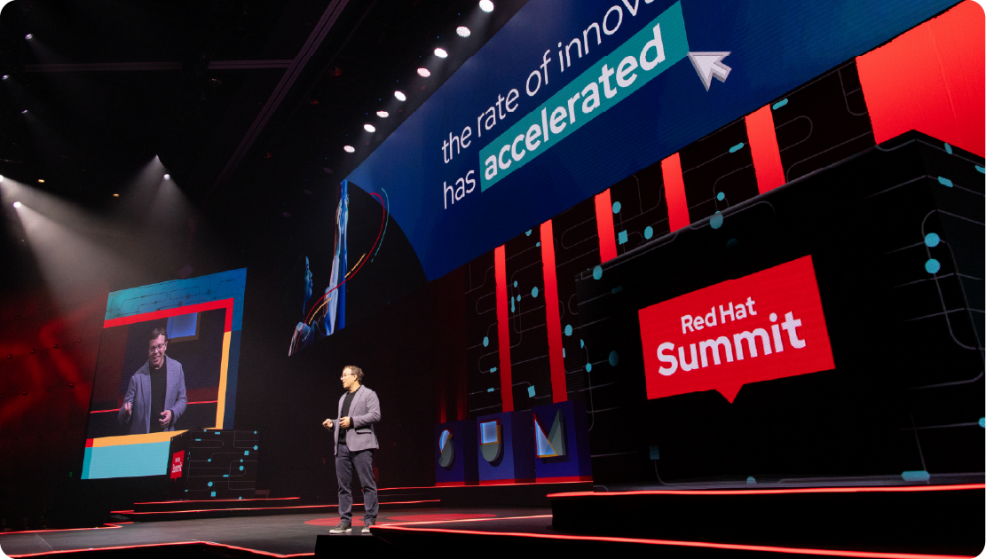 A photo shows Red Hat CEO Matt Hicks presenting at Red Hat Summit.