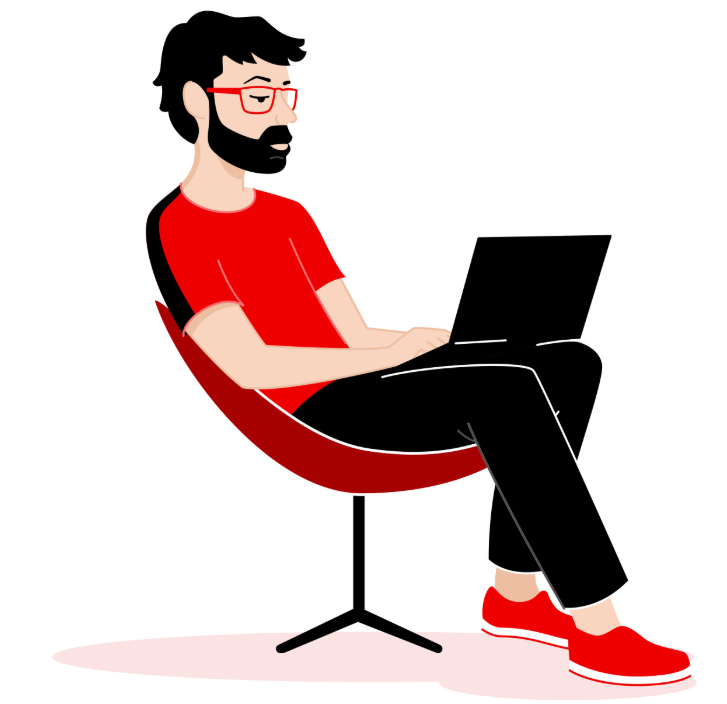 Man with beard sitting in chair working on laptop