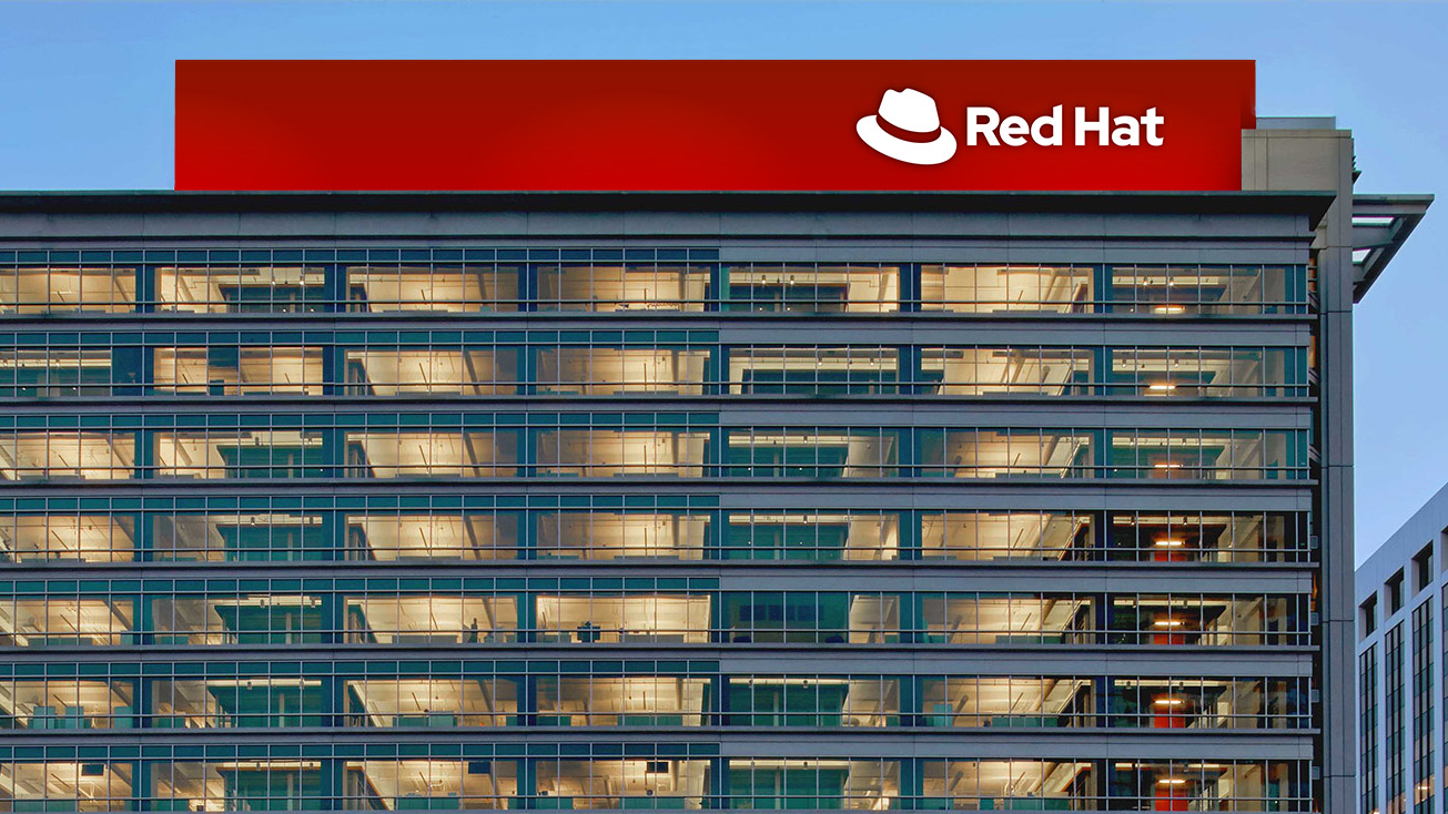 The top of Red Hat Tower, featuring a red band with a one-color white logo.