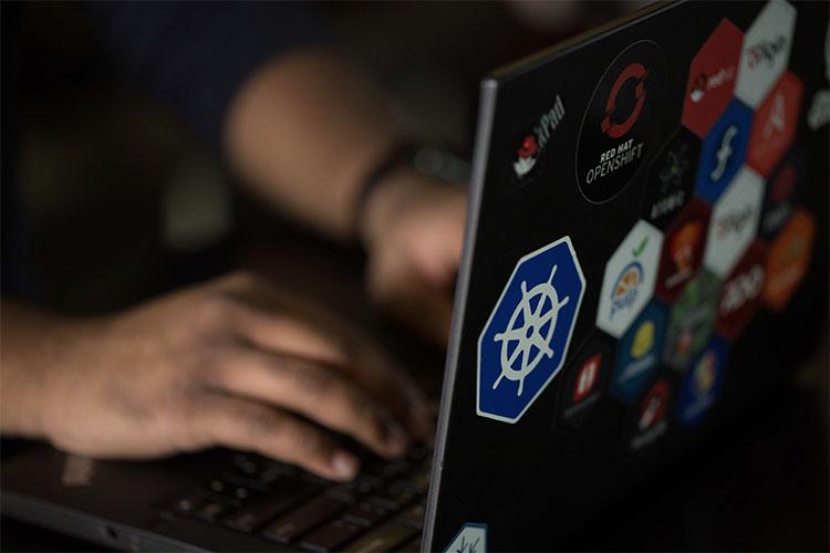 user with stickers on laptop