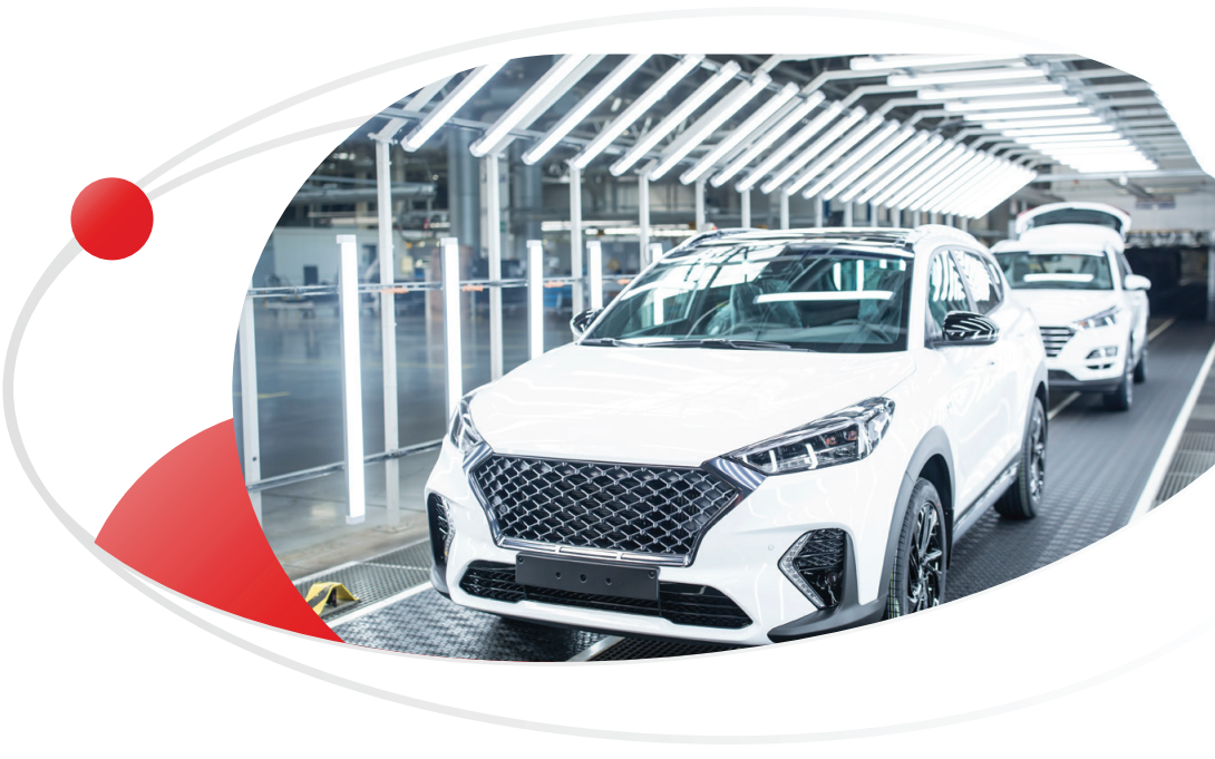 A white SUV is shown on an illuminated automotive assembly line, highlighting a modern car manufacturing process.